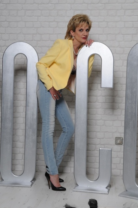 Classy older lady Lady Sonia uncovers her big tits prior to removing her jeans