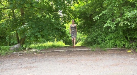 Caucasian chick Valentina Ross squats to pee in a parking lot near the woods