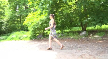 Caucasian chick Valentina Ross squats to pee in a parking lot near the woods
