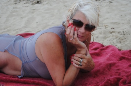 Older blonde amateur Dimonty models at the beach in see thru attire and shades