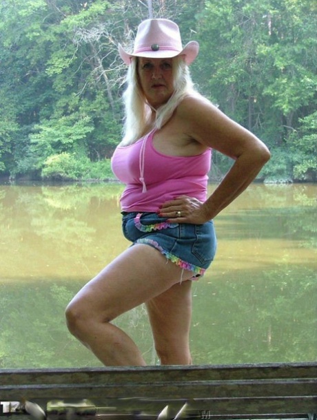 Older blonde Adonna makes her nude debut on a waterside deck