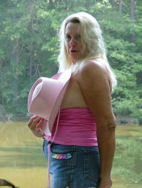 Older blonde Adonna makes her nude debut on a waterside deck