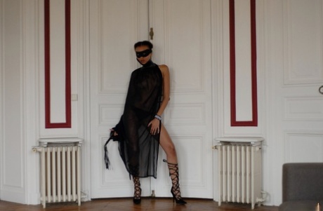 Brazilian female Angelique exposes her long legs while wearing a mask