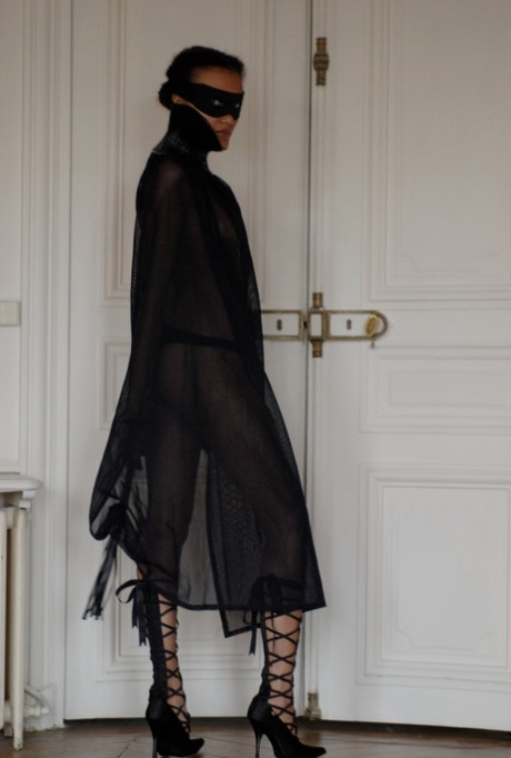 Brazilian female Angelique exposes her long legs while wearing a mask