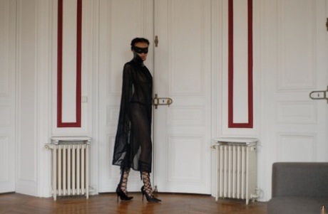 Brazilian female Angelique exposes her long legs while wearing a mask