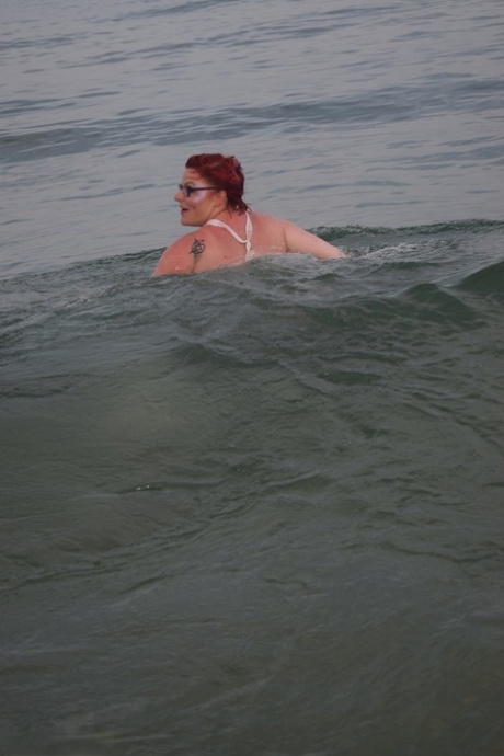 Tattooed redhead poses nude on a beach before masturbating on a toilet seat