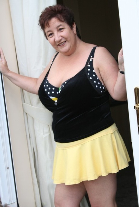 Fat older woman Kinky Carol flashes her bra and upskirt underwear on a patio