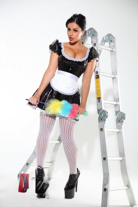 Dark-haired beauty Jasmine Jones models a latex maid uniform in sexy stockings