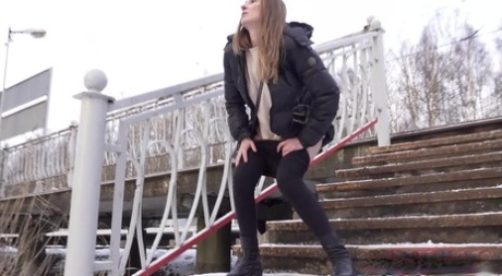 Caucasian female Valya takes a piss on snow-covered steps in public