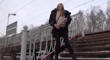 Caucasian female Valya takes a piss on snow-covered steps in public