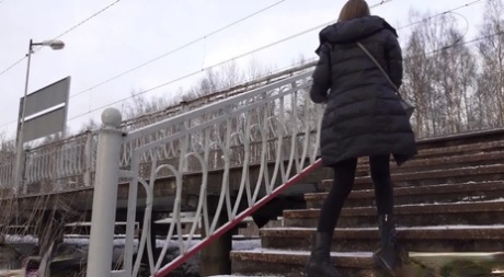 Caucasian female Valya takes a piss on snow-covered steps in public