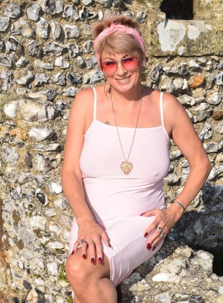 Mature lady Dimonty exposes her tits and pussy at a historical site