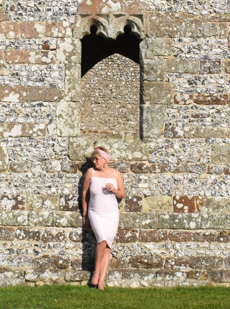 Mature lady Dimonty exposes her tits and pussy at a historical site
