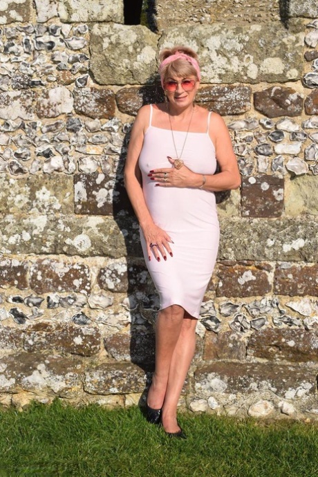 Mature lady Dimonty exposes her tits and pussy at a historical site