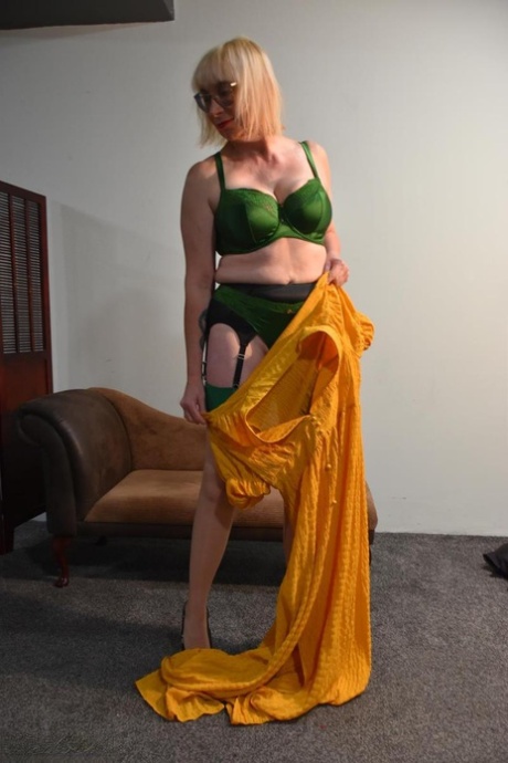 Mature amateur Barby Slut takes off a long dress to model in her underthings