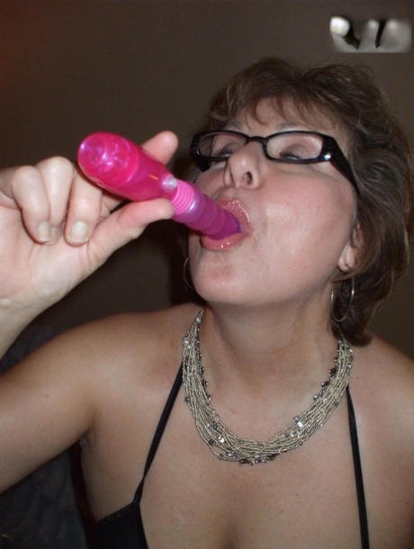 Older lady Busty Bliss shows her natural tits while playing with a sex toy