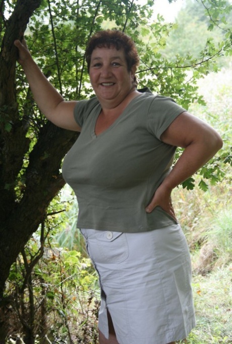 Mature BBW Kinky Carol strips to her lingerie in a wooded setting