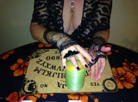 Older lady Busty Bliss releases her natural tits over a Ouija board