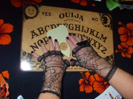 Older lady Busty Bliss releases her natural tits over a Ouija board