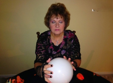 Older lady Busty Bliss releases her natural tits over a Ouija board