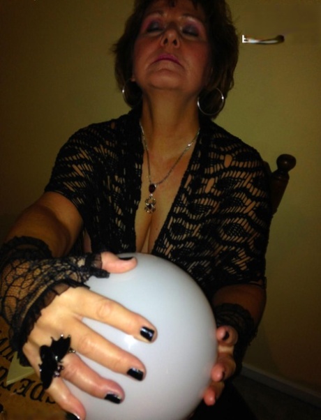 Older lady Busty Bliss releases her natural tits over a Ouija board