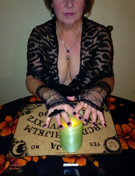 Older lady Busty Bliss releases her natural tits over a Ouija board