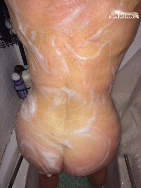 Mature plumper Busty Bliss gives her man friend a blowjob while showering