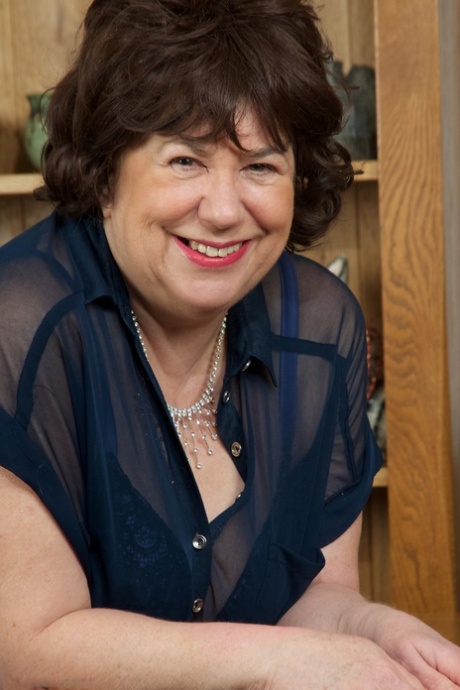 Busty mature plumper masturbates with a vibrator in hosiery and boots