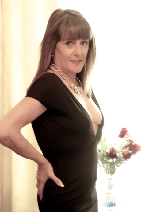 Mature woman Dirty Doctor covers up her naked tits while wearing sexy heels