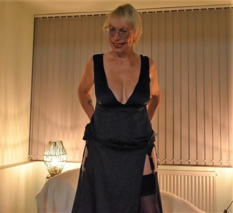 Mature British lady with blonde hair Barby Slut goes nude in black nylons