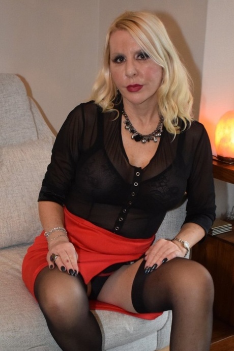 Sexy older blonde Emerald exposes her garters and panties during upskirt play