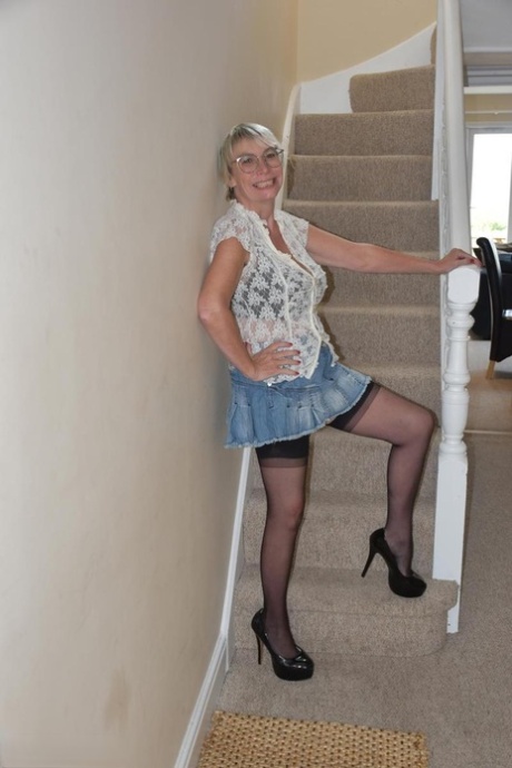 Mature British woman Barby Slut shows her big tits and snatch on the stairs