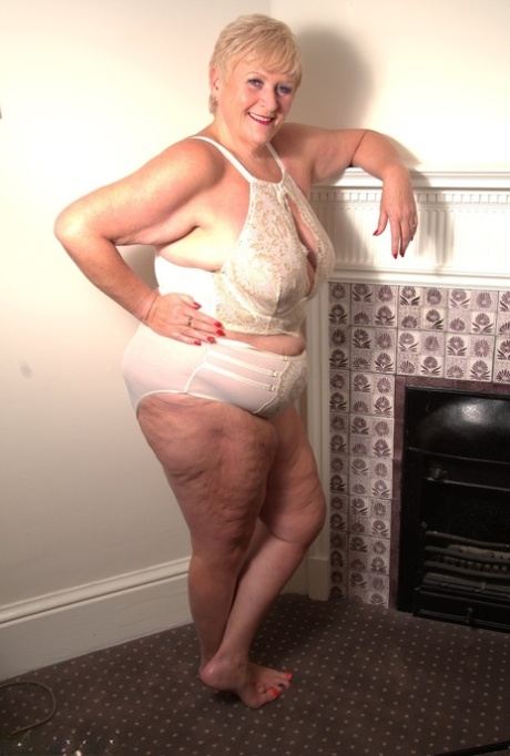 Mature fatty with short blonde hair gets completely naked on her bed