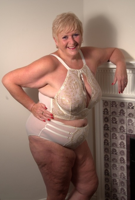 Mature fatty with short blonde hair gets completely naked on her bed