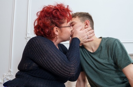 Mature redheaded plumper sports glasses during sex with her stepson