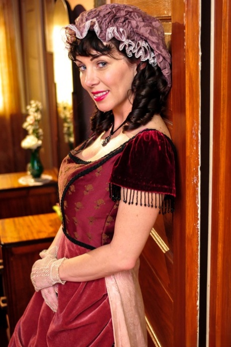 Hot mature brunette RayVeness shows sexy cleavage wearing medieval costume