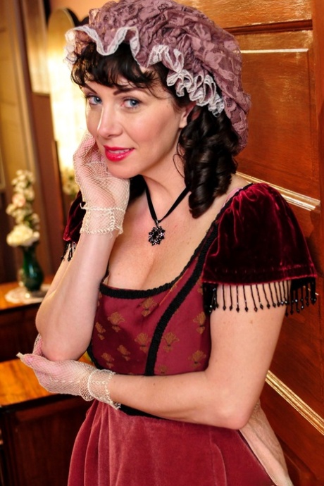 Hot mature brunette RayVeness shows sexy cleavage wearing medieval costume