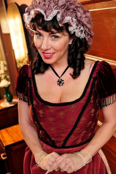 Hot mature brunette RayVeness shows sexy cleavage wearing medieval costume