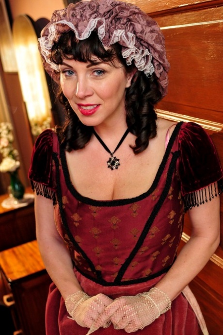 Hot mature brunette RayVeness shows sexy cleavage wearing medieval costume