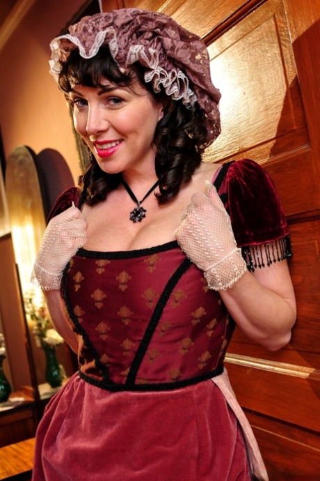 Hot mature brunette RayVeness shows sexy cleavage wearing medieval costume