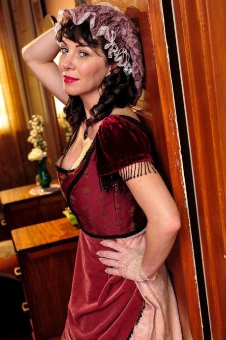 Hot mature brunette RayVeness shows sexy cleavage wearing medieval costume