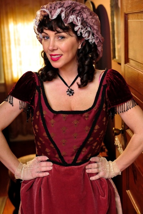 Hot mature brunette RayVeness shows sexy cleavage wearing medieval costume