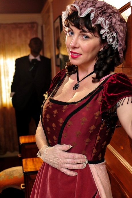 Hot mature brunette RayVeness shows sexy cleavage wearing medieval costume
