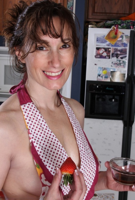 Middle-aged lady Celeste Carpenter takes off her apron to pose nude in kitchen