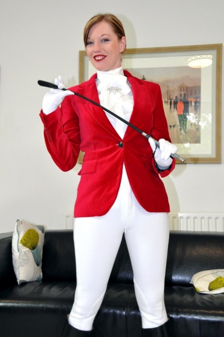 Sexy redhead Holly wears her riding attire while having sex with an old man