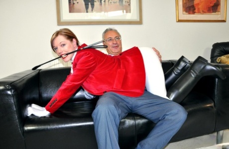 Sexy redhead Holly wears her riding attire while having sex with an old man