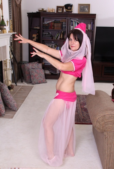 30 plus woman Sherry Lee removes her genie costume to model in the nude