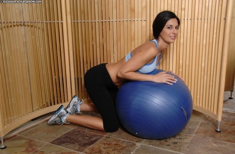 Alluring mature brunette in sport outfit revealing her tits and juicy slit