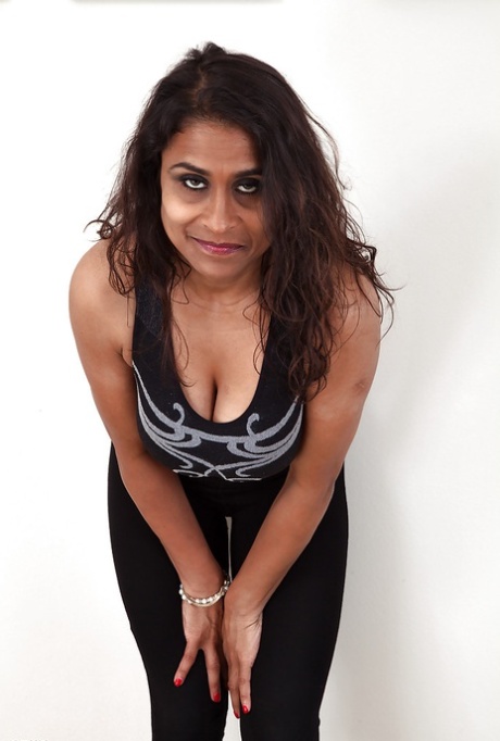 Dirty-minded mature lassie undressing and exposing her shaggy twat