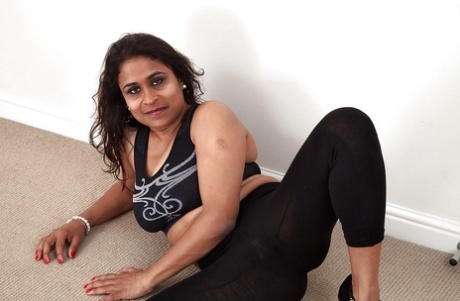 Dirty-minded mature lassie undressing and exposing her shaggy twat